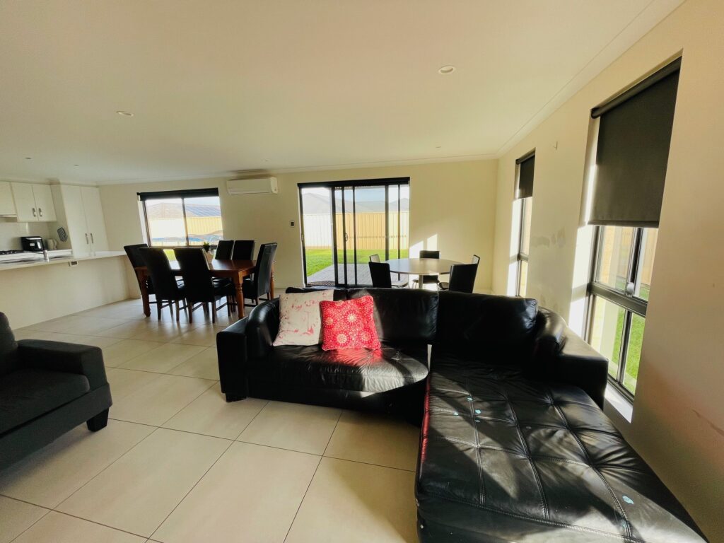 Community Living Association Baltic Ridge view of open plan kitchen, dinning and longue area with view of back garden and double sliding doors.